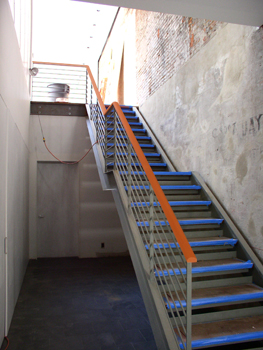 Main entry stair during construction.  Blue tape protects tread edges.