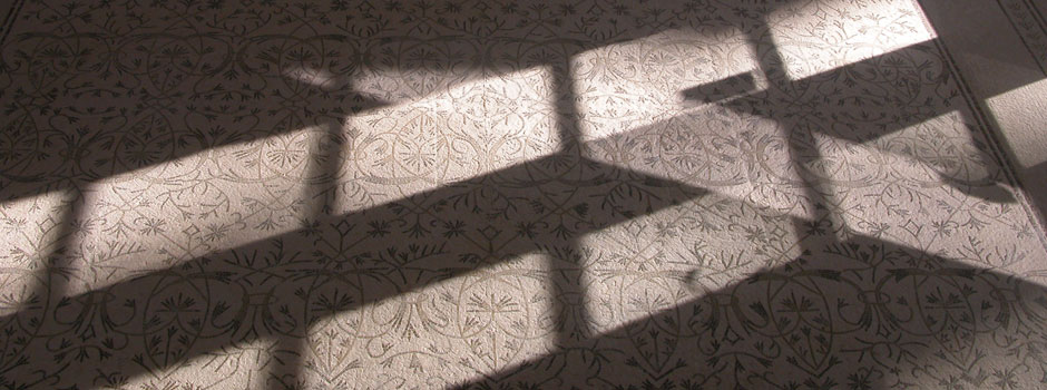 Light pattern across mosaic tile floor in pool room vestibule